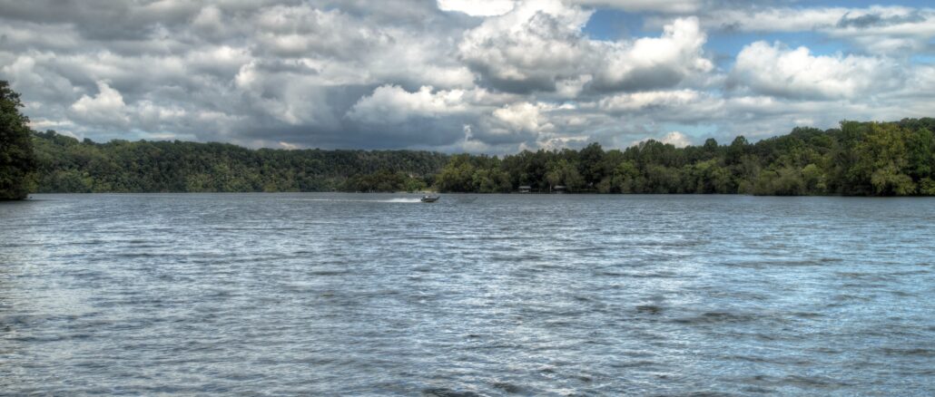 View of watts bar lake in east tennessee on cloudy day with boat in the distance on waves