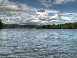 View of watts bar lake in east tennessee on cloudy day with boat in the distance on waves